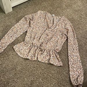 Button up medium long sleeve top. Tight around the waist & flares out at bottom